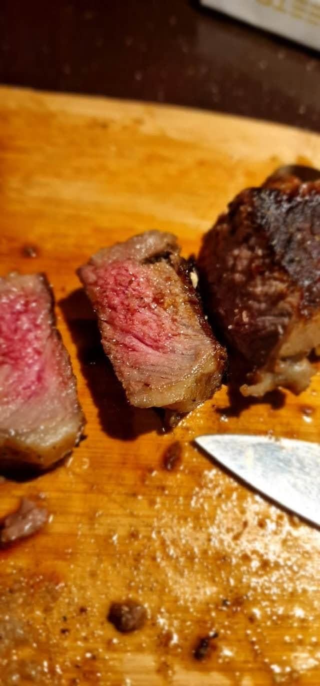 Sliced pork neck on a wooden board