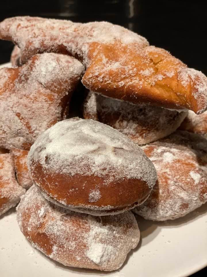 Homemade papanași dusted with sugar