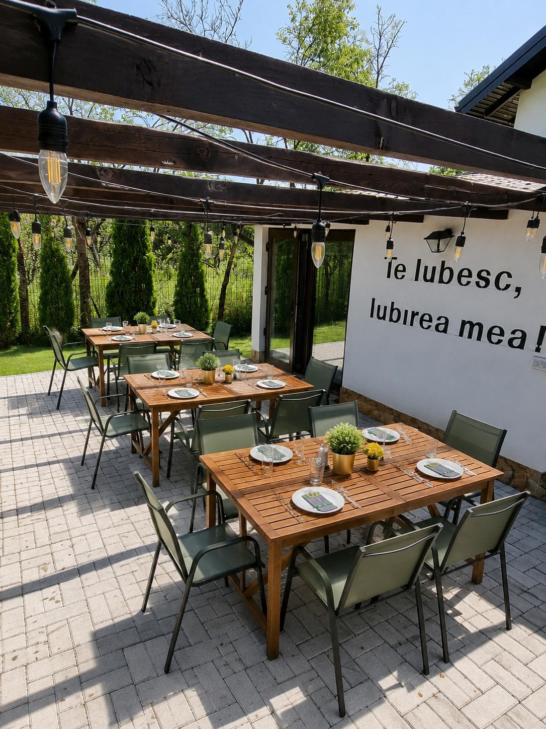 The pergola-covered terrace, with wooden tables set for guests